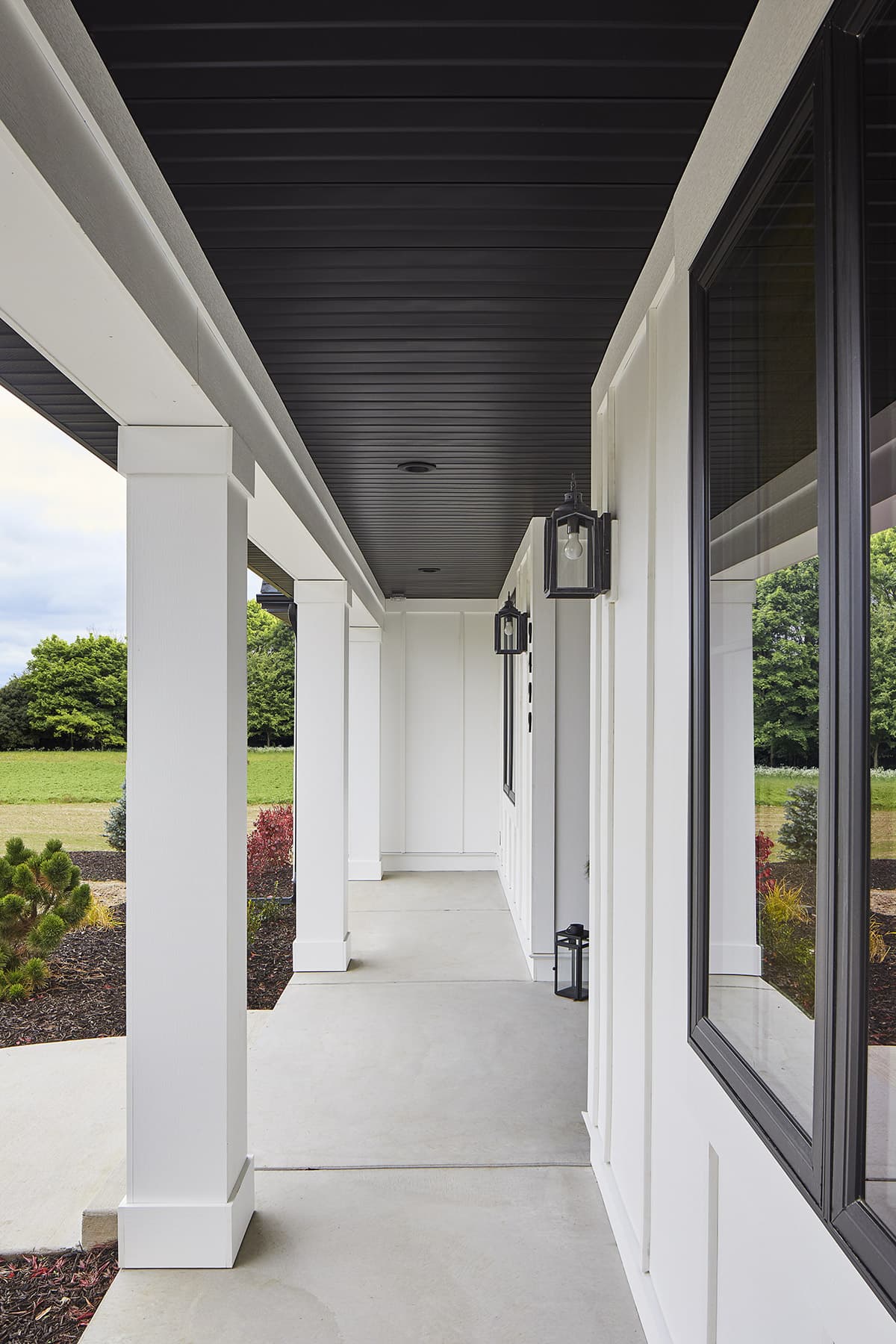 A porch on a home clad in cellular-PVC board-and-batten siding