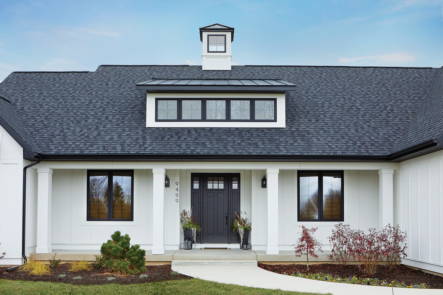 A coastal or modern-farmhouse home clad in AZEK cellular-PVC board-and-batten siding