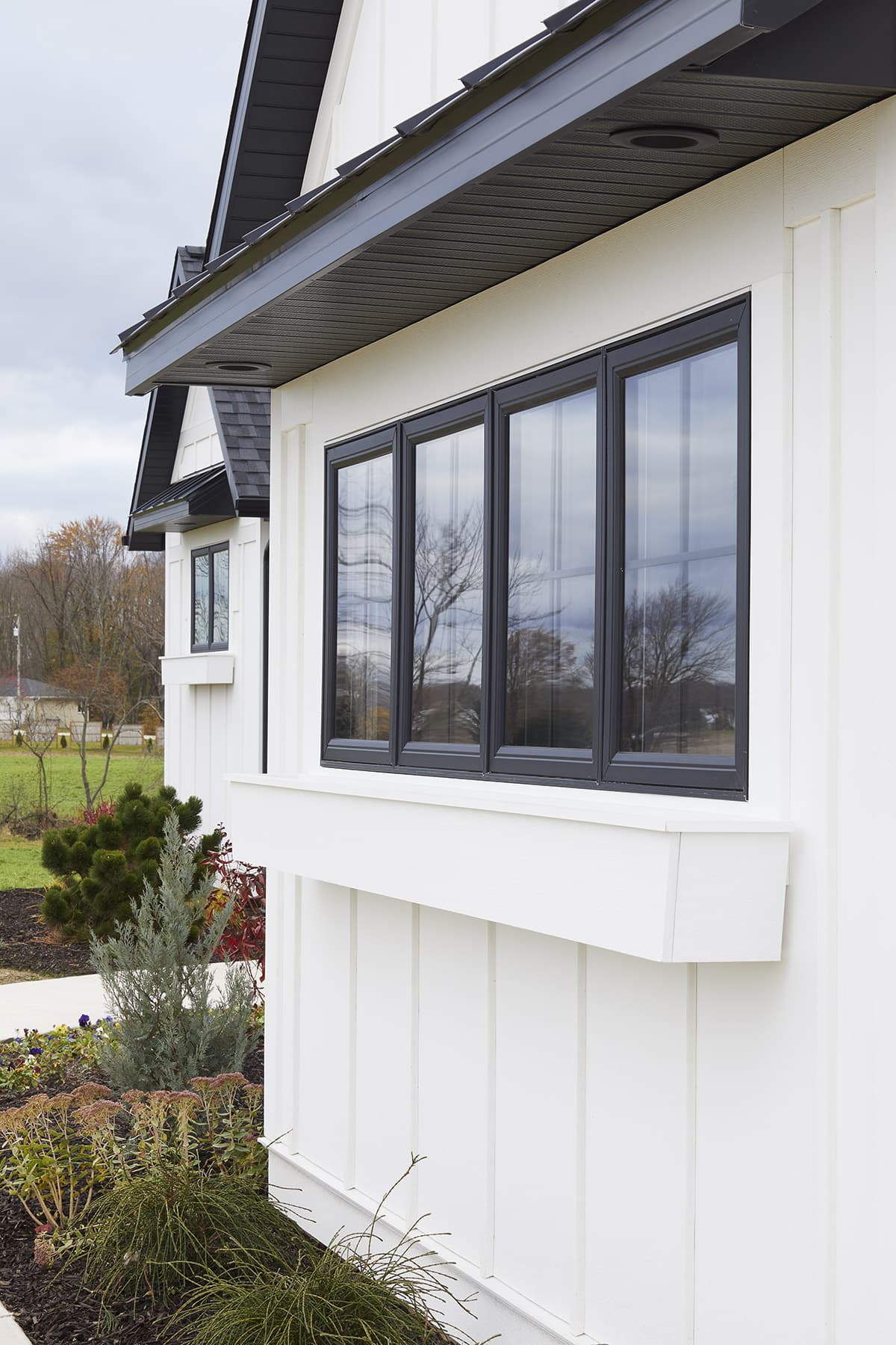 A coastal or modern-farmhouse home clad in AZEK cellular-PVC board-and-batten siding