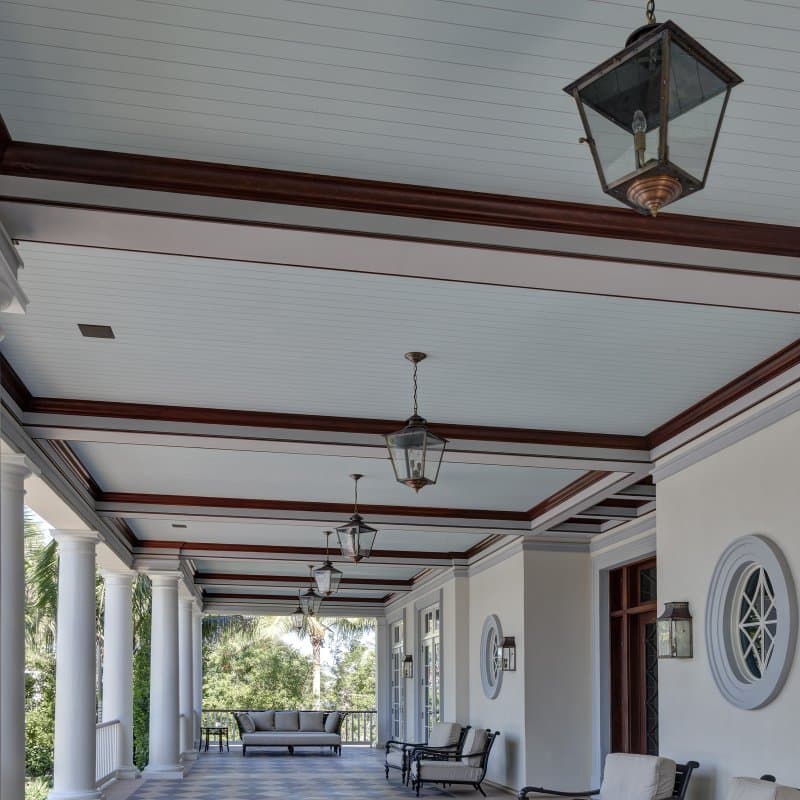 A covered porch with composite poly-ash trim and siding