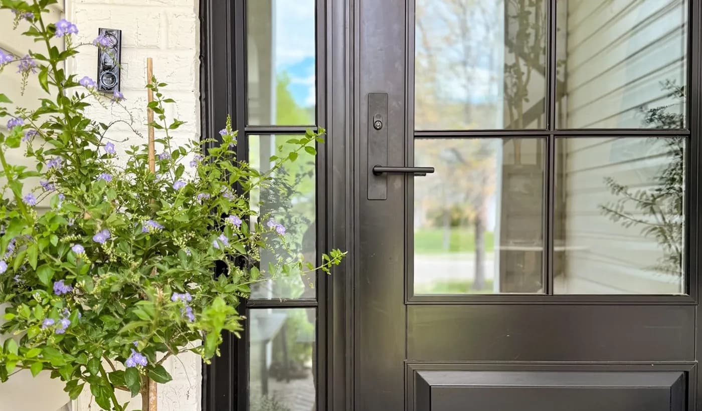 A modern Andersen entry door set in a covered front entry