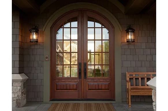 An Andersen entry door framed by sidelights in a finished entryway