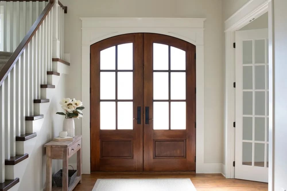 A farmhouse-style wood Pella entry door on a residential front elevation