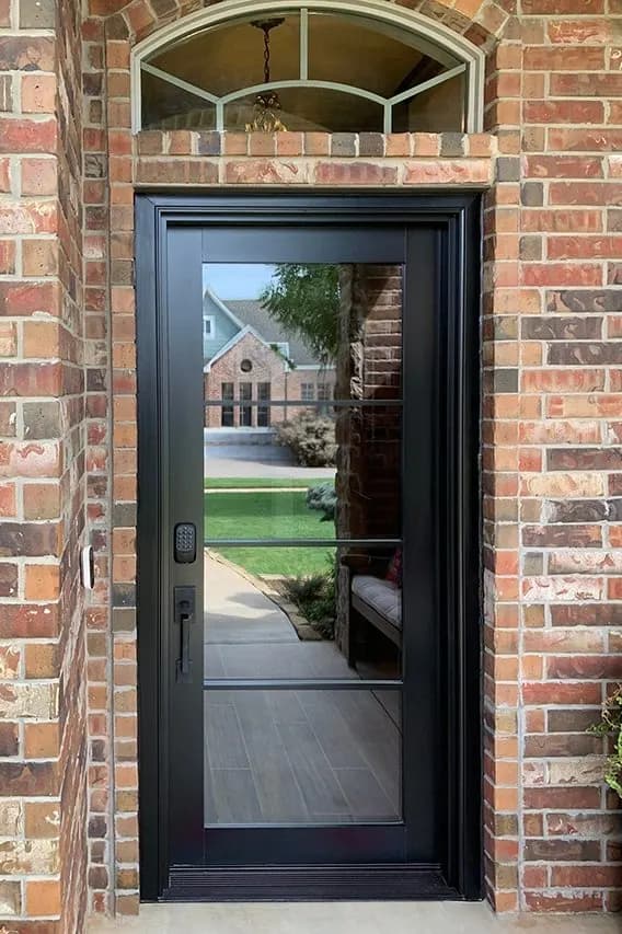 A black Pella entry door framed by sidelights in a finished entryway