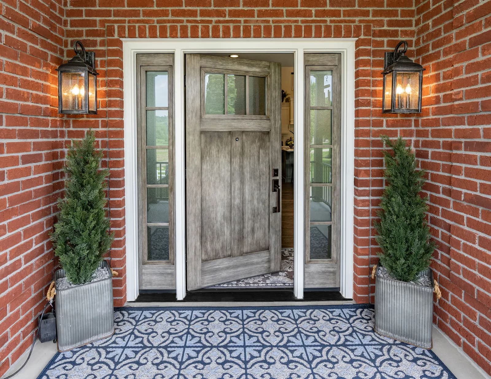 A warm-stained fiberglass ProVia entry door on a home's front entry