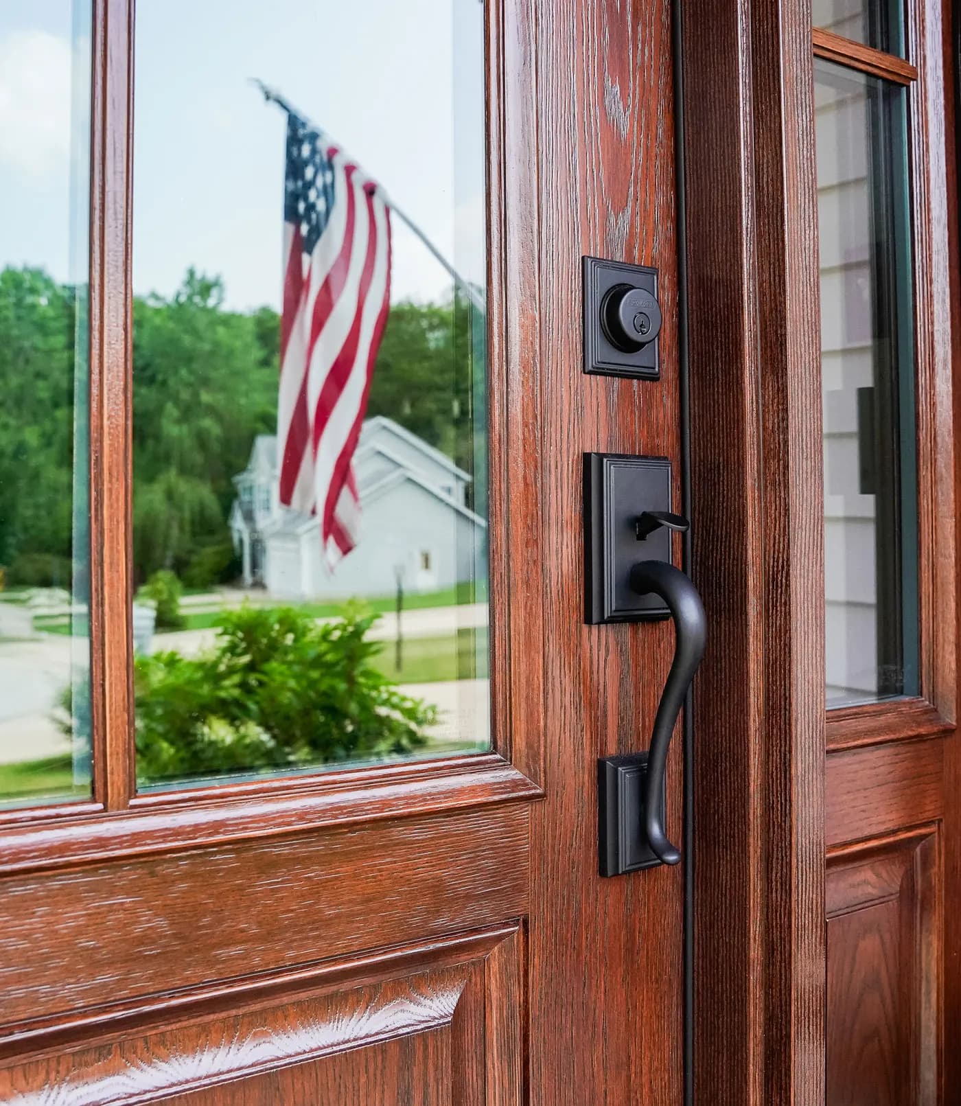 A warm-stained fiberglass ProVia entry door anchoring a home's curb appeal