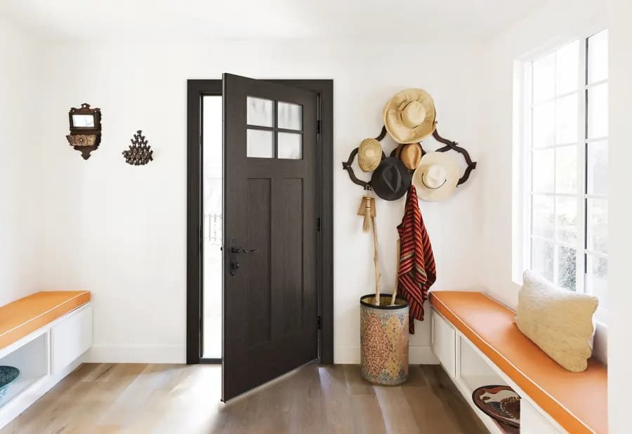 A Therma-Tru entry door framed by sidelights in a finished entryway