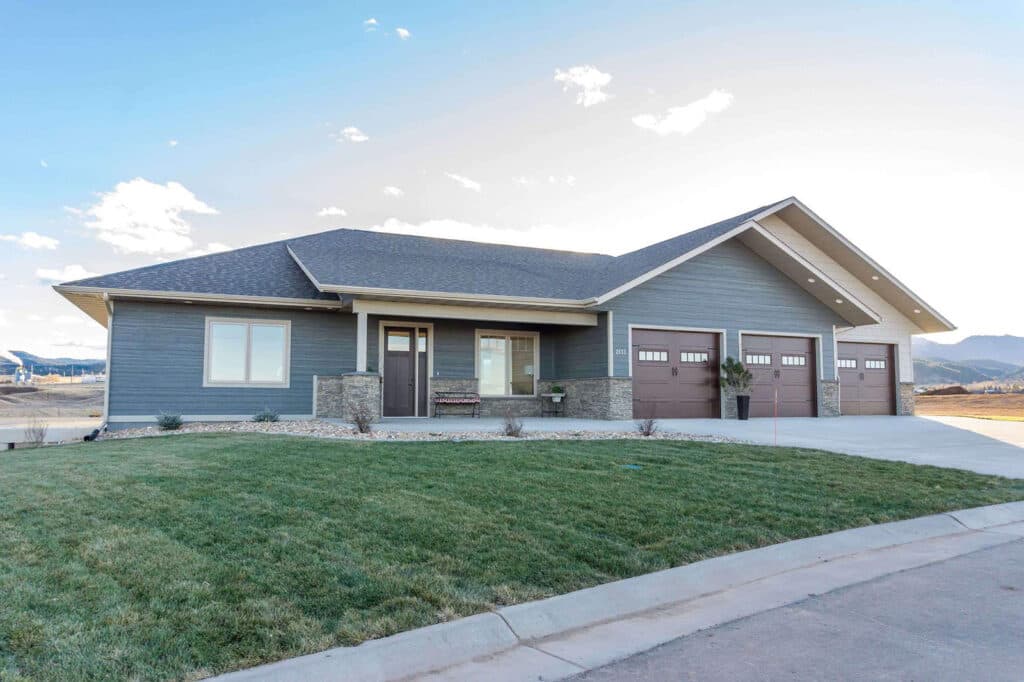 A smoky blue-gray craftsman ranch with stone and shake accents clad in LP SmartSide