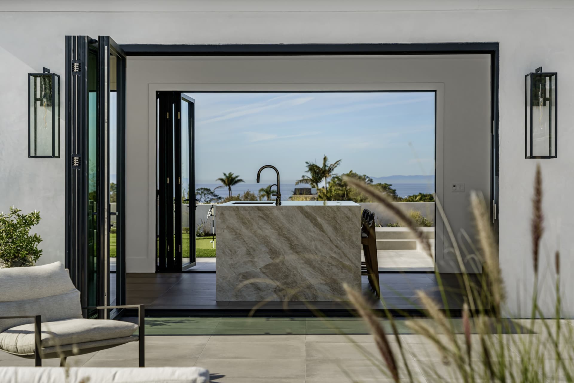 LaCantina opening glass wall opening a room onto a deck and yard