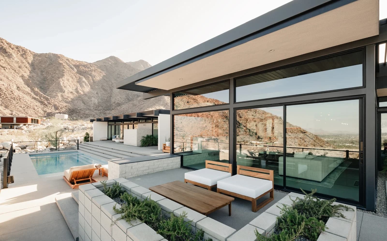 Western multi-slide glass wall framing an indoor-outdoor living space