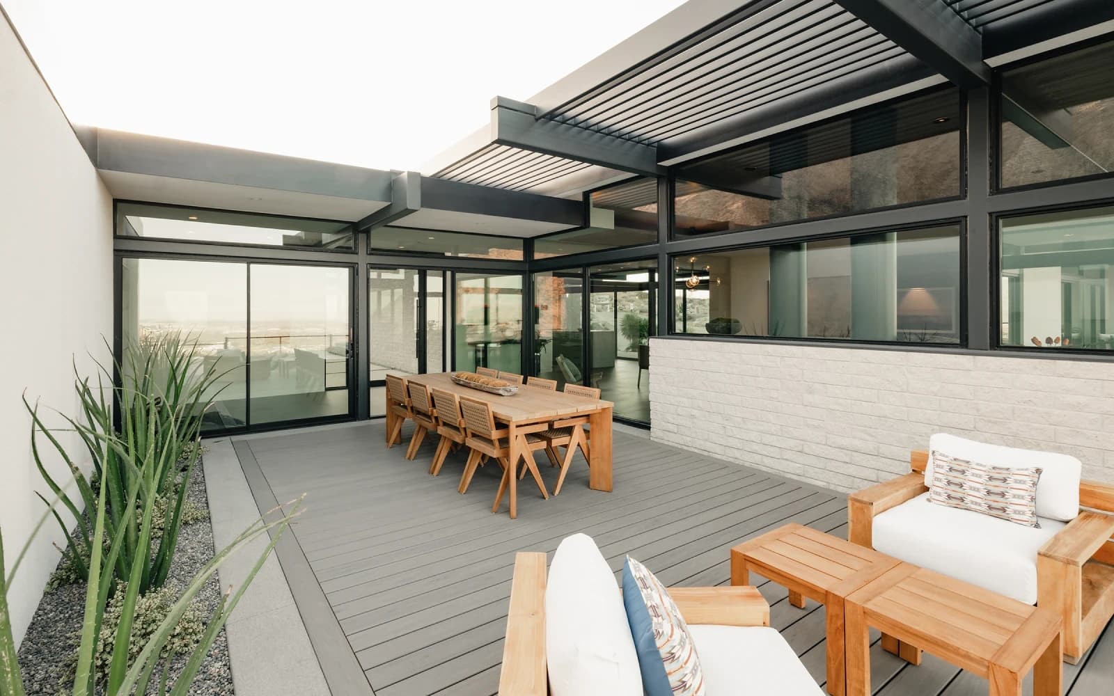 Western multi-slide glass wall opening a living space to the patio
