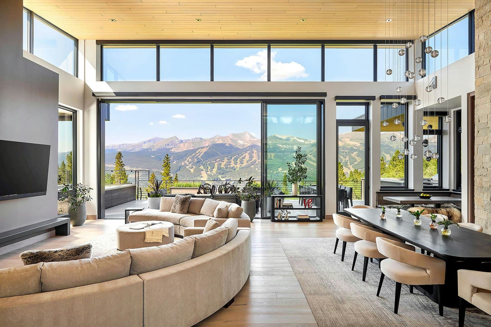 NanaWall multi-slide glass wall opening a room onto a deck and yard
