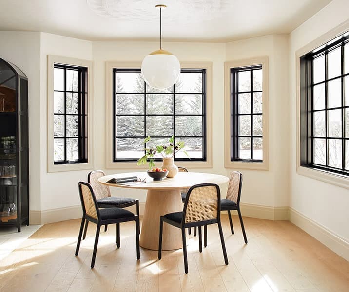 Wood-interior Pella windows in a contemporary dining room